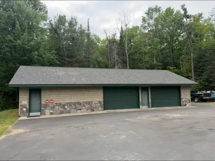Detached garage with new roof and green doors